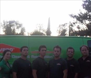 Crew of SERVPRO employees in front of a SERVPRO Van 